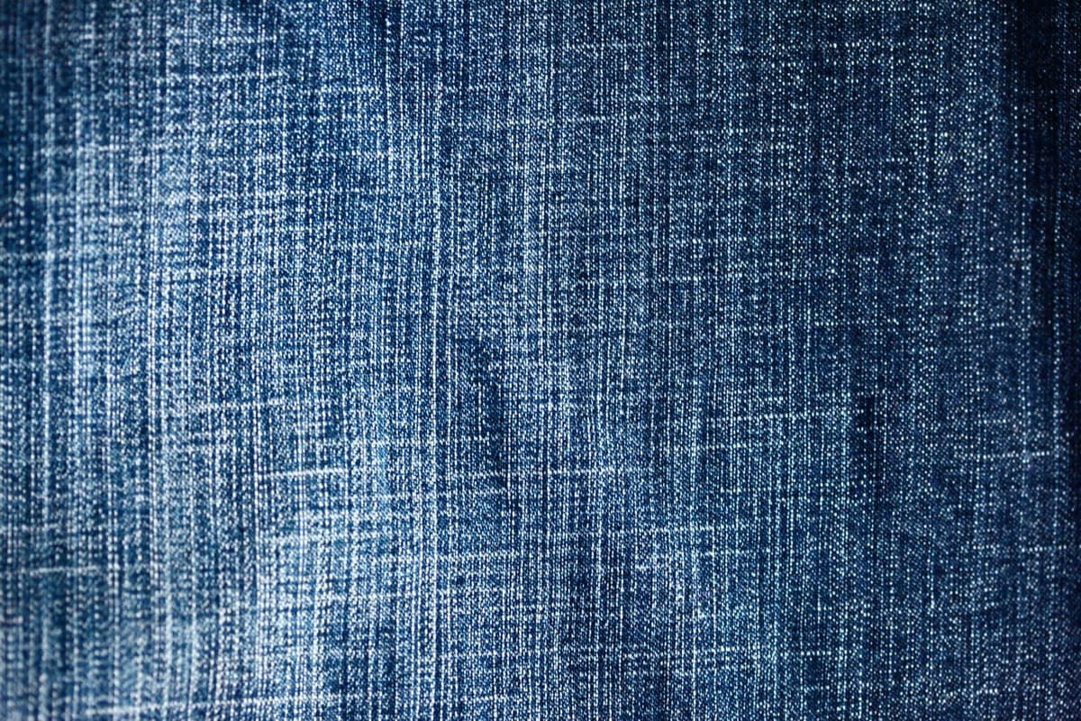 A close, textured view of blue denim fabric weave