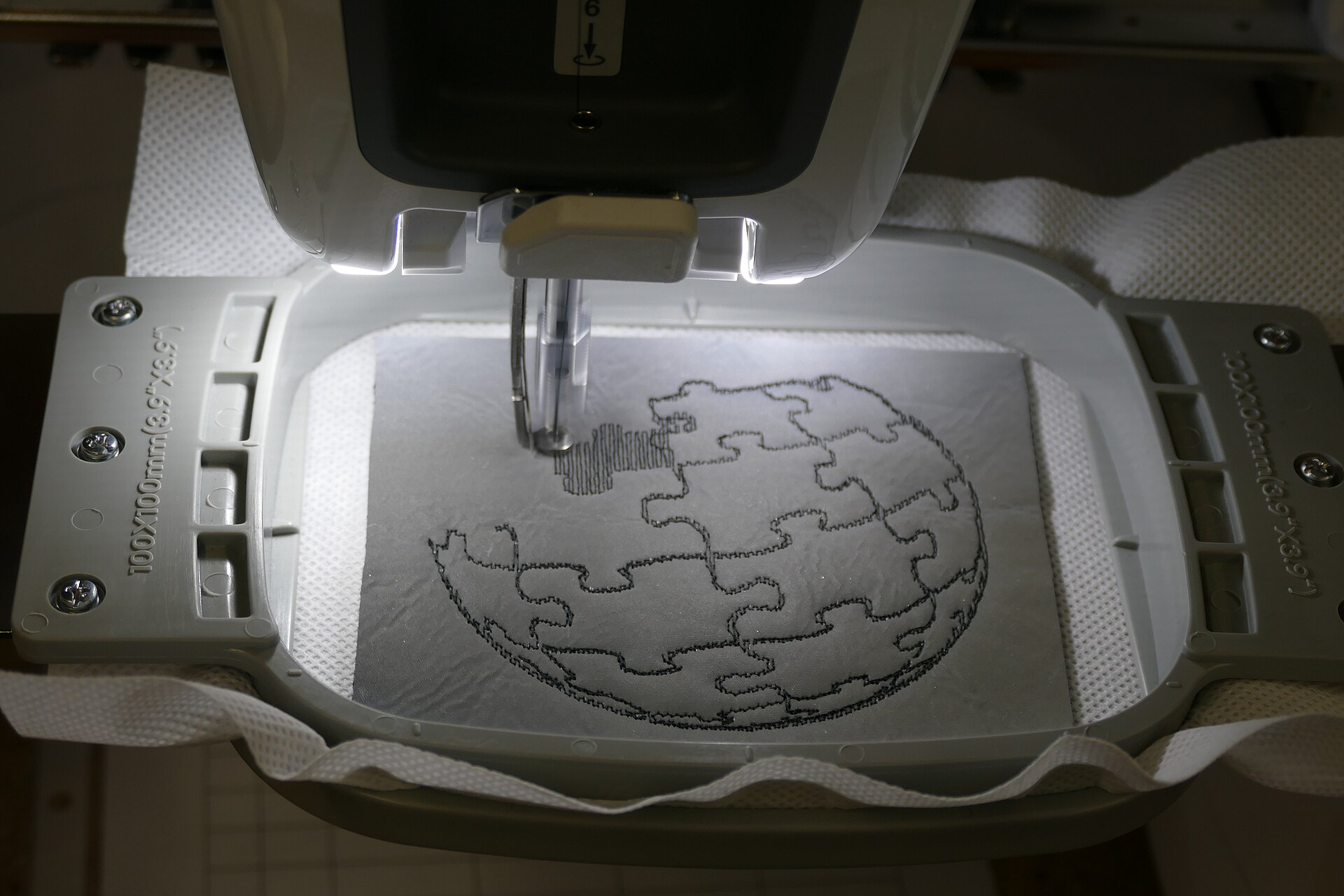 A home embroidery machine set up to stitch