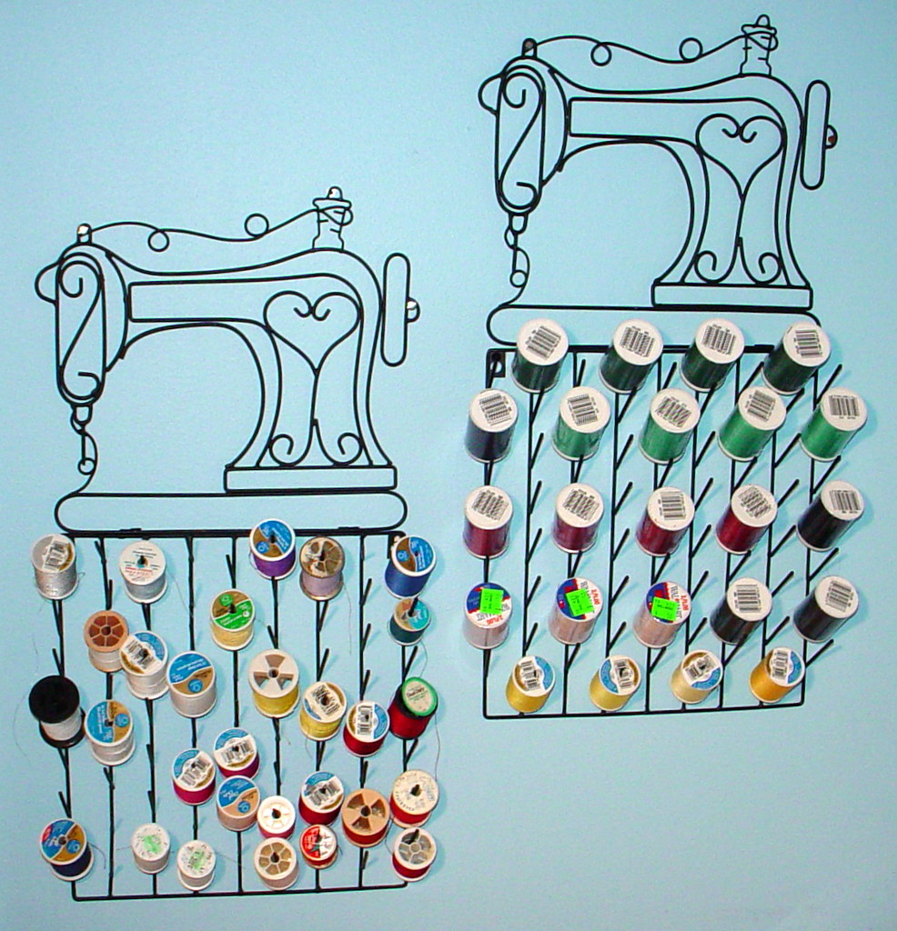 Large organized rack of thread cones in multiple colors in a sewing and embroidery workspace