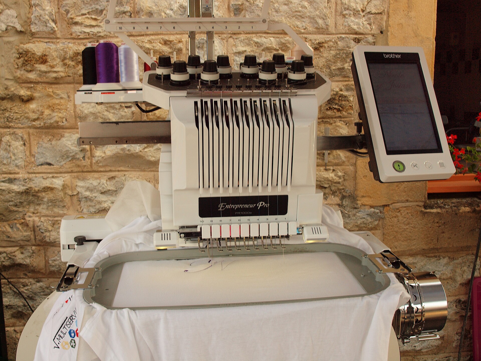 A Brother embroidery machine on display showing the touchscreen and machine body setup