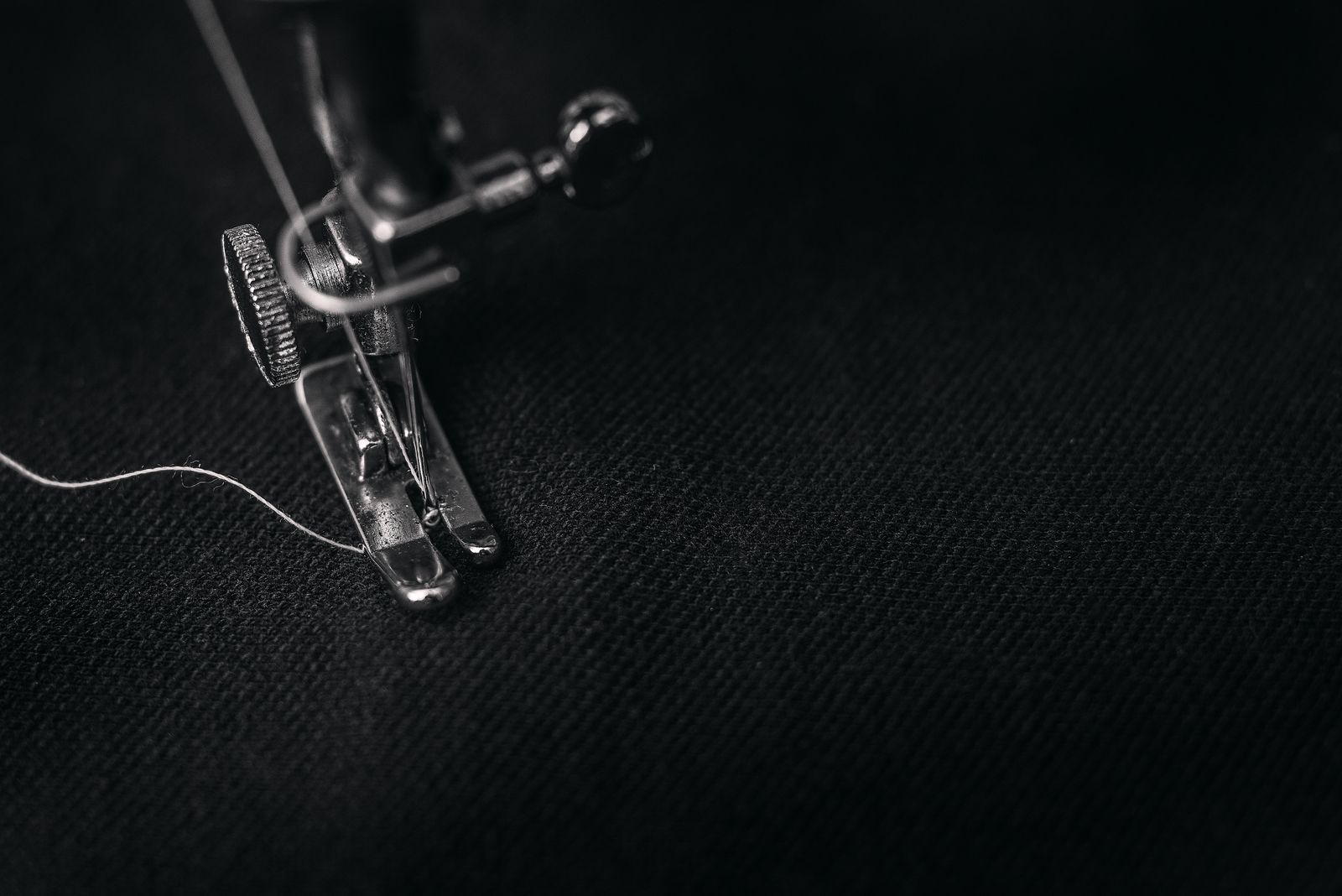 Close-up of multiple needle positions on a commercial embroidery machine showing colored threads