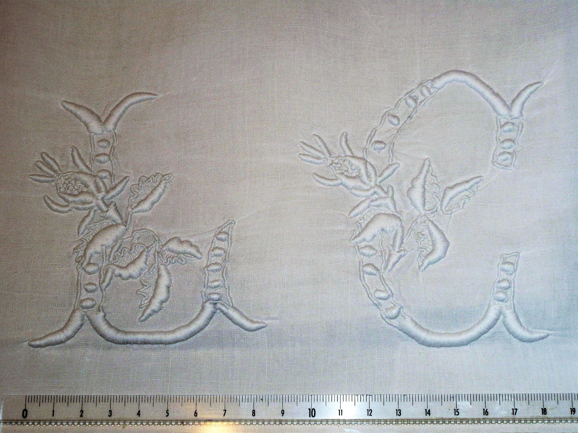 An embroidered monogram of letters on fabric