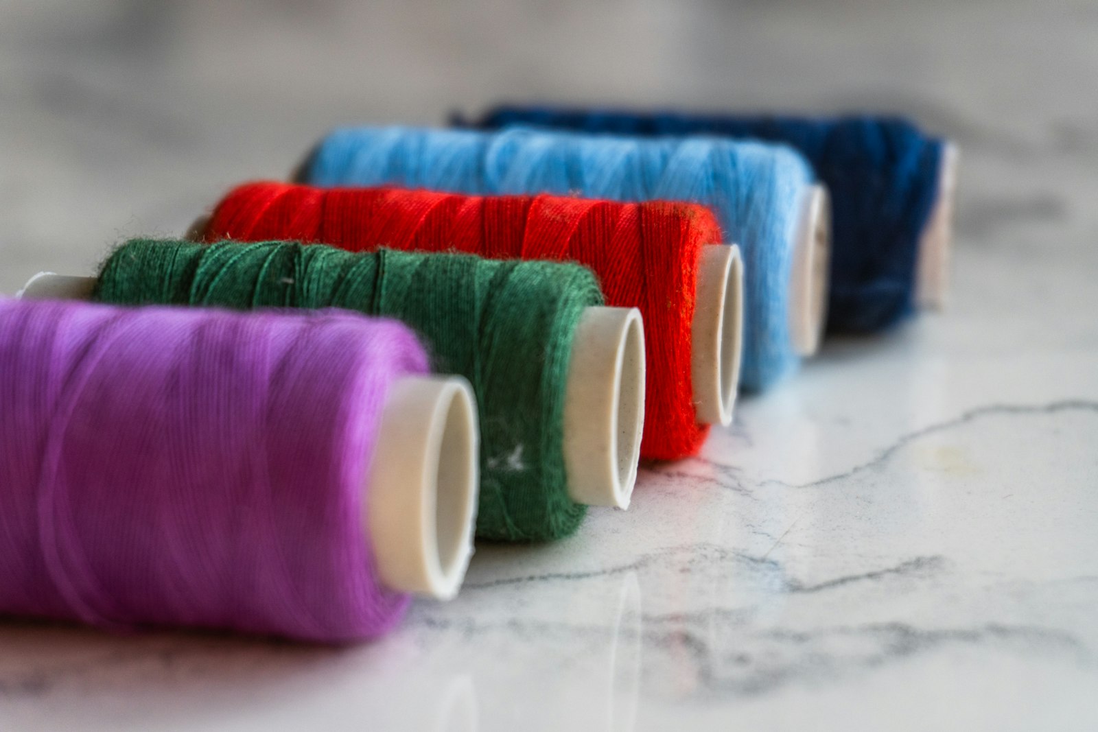 Rows of colorful embroidery thread spools arranged in a line