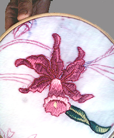Traditional hand-stitched textile craftwork showing careful thread detail on handmade fabric